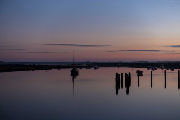 A pastel hued winter sunrise on a calm, but cold morning at Burnham Overy Staithe, Norfolk.